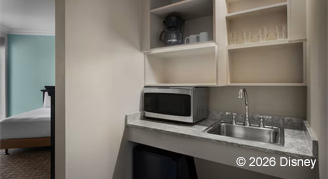 Mobility accessible deluxe studio with a kitchenette area featuring microwave, minifridge, and sink.