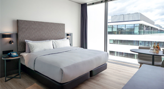 Photo of hotel room with large window.