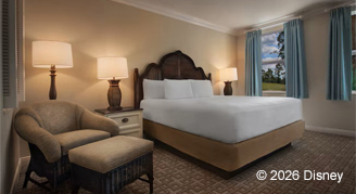 Hearing accessible room with comfortable seating area next to a king bed.