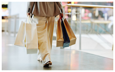 Image is of someone carrying shopping bags 