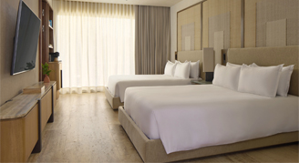 Image of two beds in a Beach Area Room.