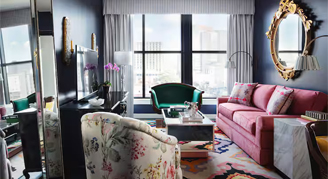 Interior view of the Graduate Suite containing a king bed that offers hearing accessible features