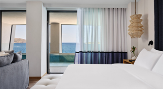 Photo of hotel room with open door to sea views.