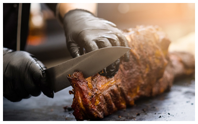 Image of barbeque meat being cut.