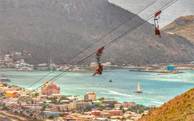 Image of two people on a zip line.